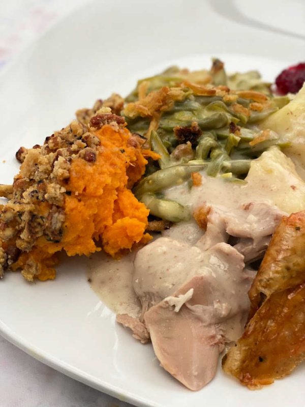 plate of thanksgiving dinner turkey sweet potato casserole green beans