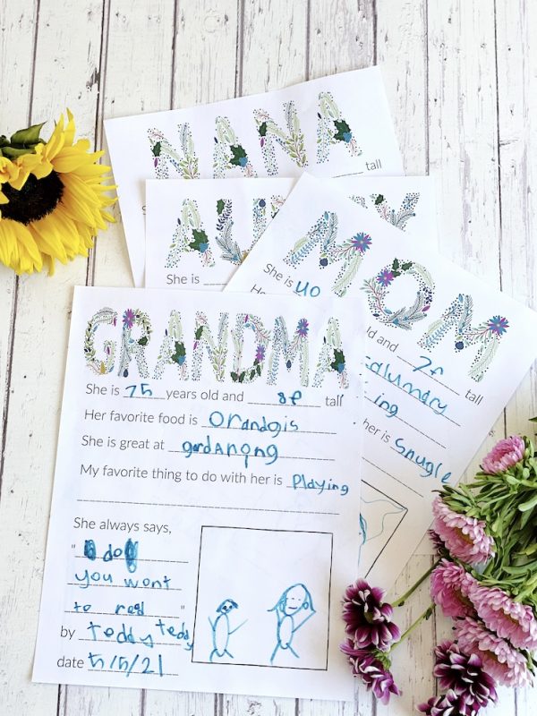 stack of Mother's Day questionnaires filled out by child and flowers