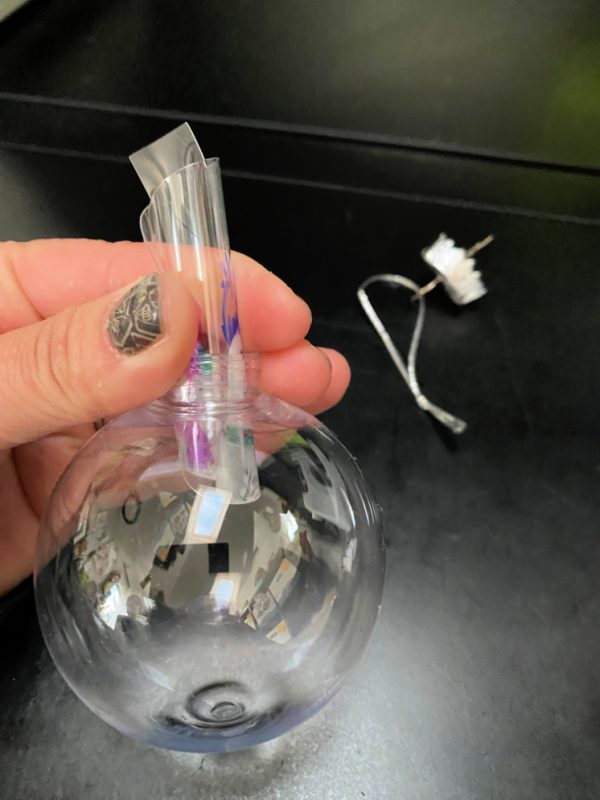 plastic disk inserting into clear ornament